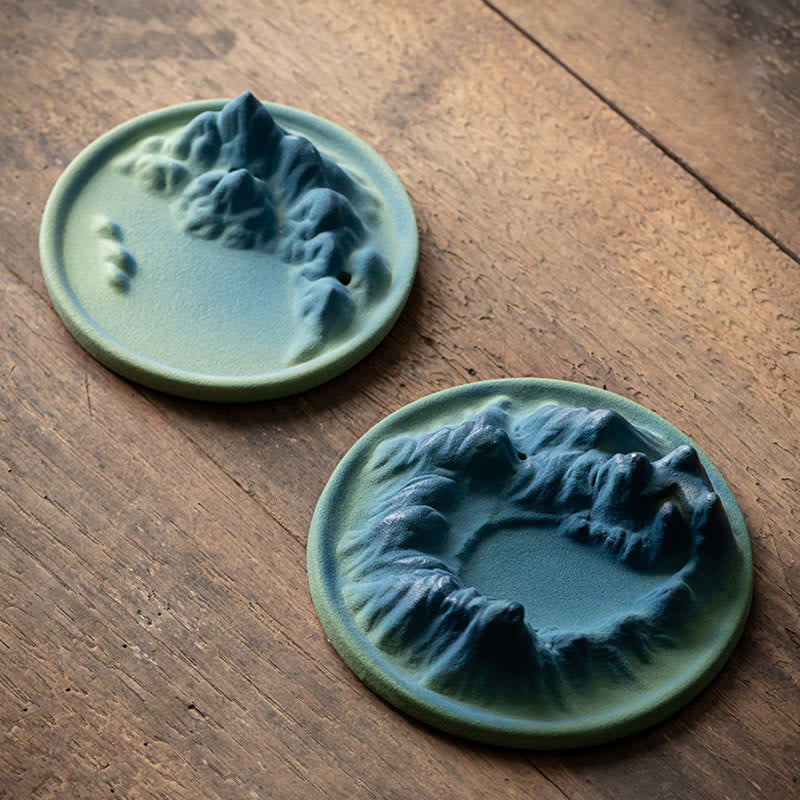 Ceramic Backflow Incense Burner – Two sage-green mountain pieces on aged wood, unlit sculptural view, zen decor
