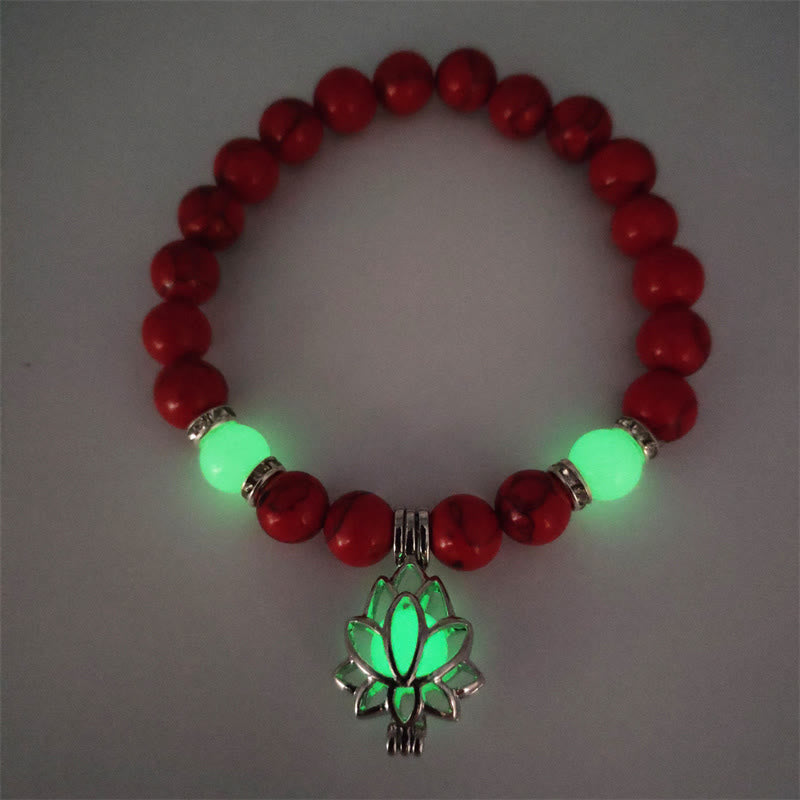 Tibetan Turquoise Glowstone Lotus Bracelet – red cinnabar beads with green glowing lotus pendant flat lay, red lotus bracelet