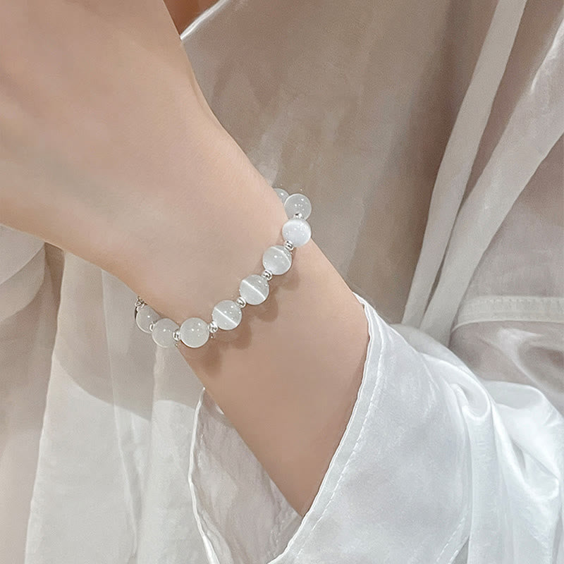 Cat's Eye PiXiu Bracelet – Wrist shot with white chiffon sleeve, delicate feminine jewelry style