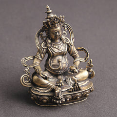 Yellow Jambhala Copper Buddha Statue – close-up of printed mantras, spiritual wellness hanging