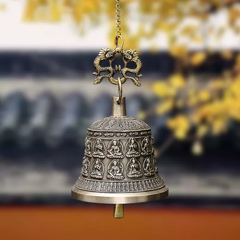 Tibetan Buddha Dragon Wind Chime Bell hanging from chain, warm bokeh background, tranquil, spiritual