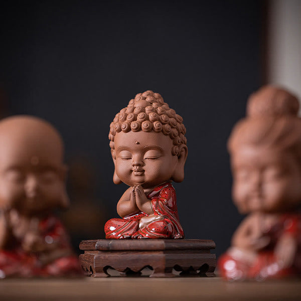 Gautama Kwan Yin Ceramic Set – figures arranged in triangle formation on desk, balanced feng shui