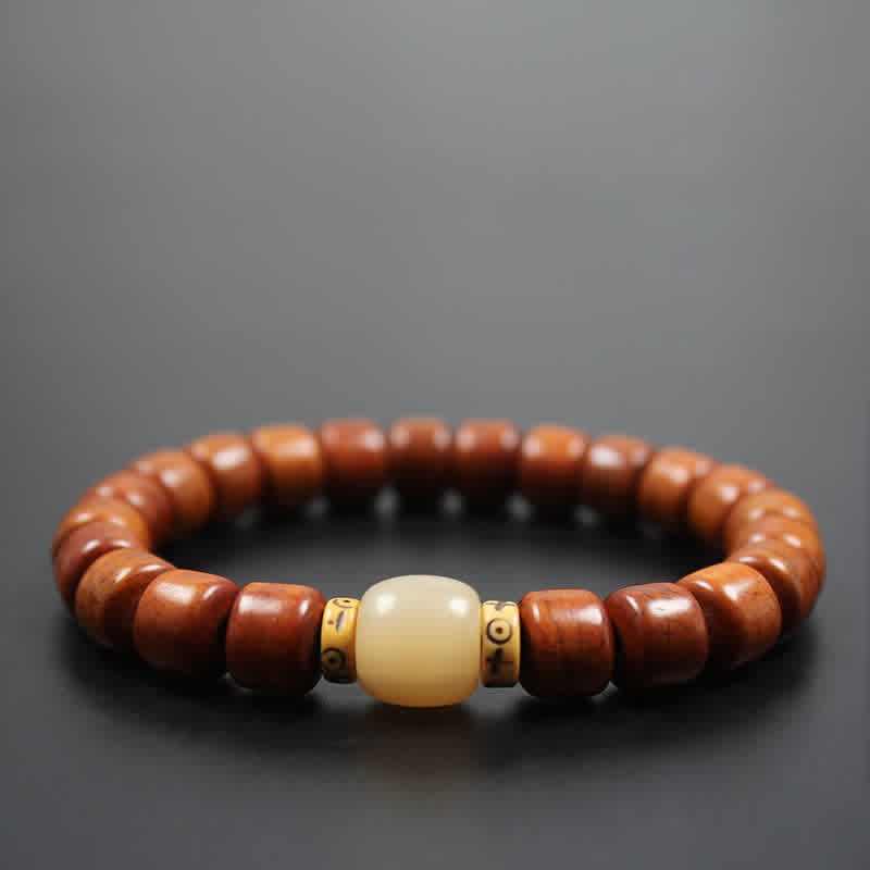Tibetan Bone Beads Om Mani Padme Hum Bracelet – brown wood beads with ivory focal and gold spacers on dark bg, zen bracelet