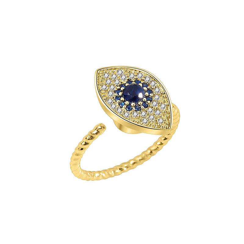 Evil Eye Rotatable Ring – Gold evil eye ring on black reflective surface, sapphire center, mirror effect