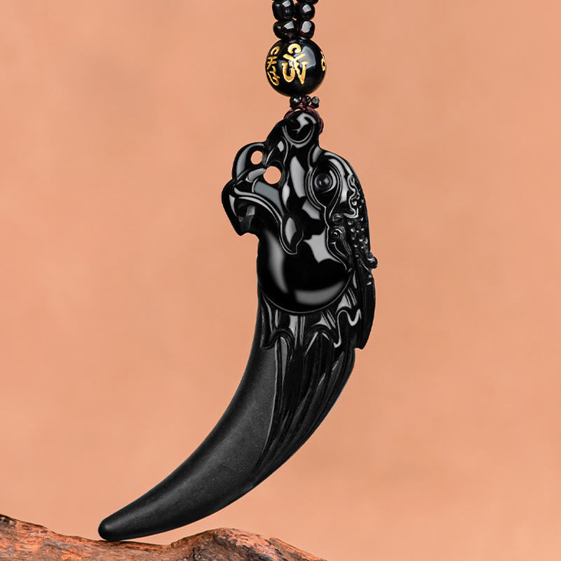 Black Jade Dragon Tooth Pendant – dragon head openwork carving on fang, wood prop, fierce protective detail