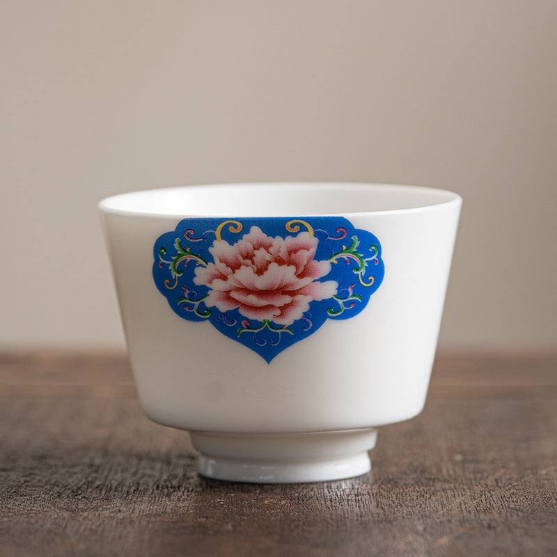 Ceramic Kung Fu Tea Cup – bronze peony with endless knot and tassel, gilded on ivory, frontal view, auspicious