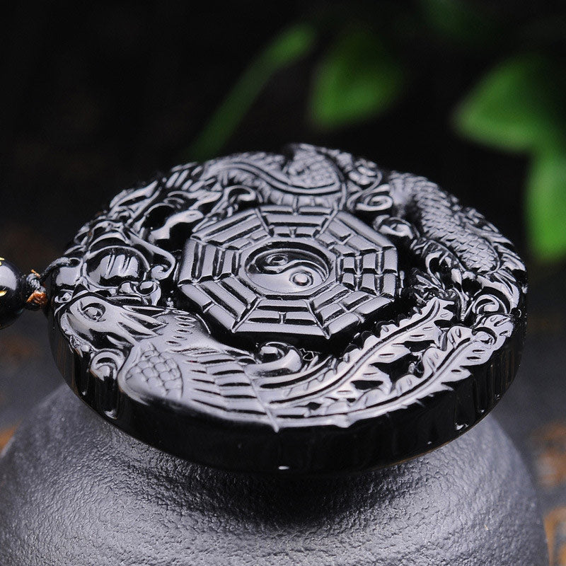 Bagua Dragon Phoenix Obsidian Pendant – Three-quarter view relief carving on stone stand, spiritual