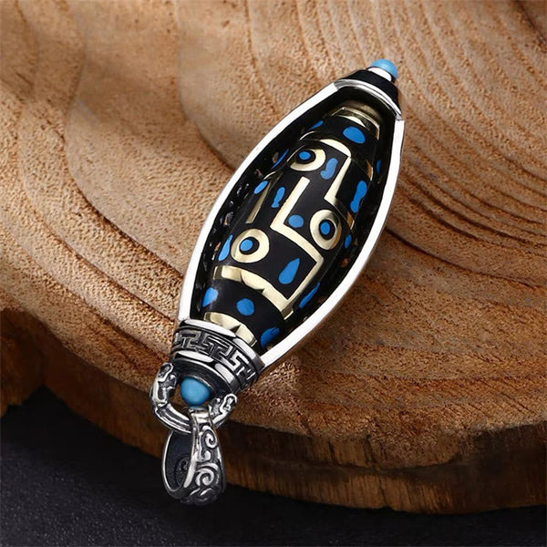 Nine-Eye Dzi Bead Pendant - Diagonal display on wood, gold and blue inlay on black dzi bead