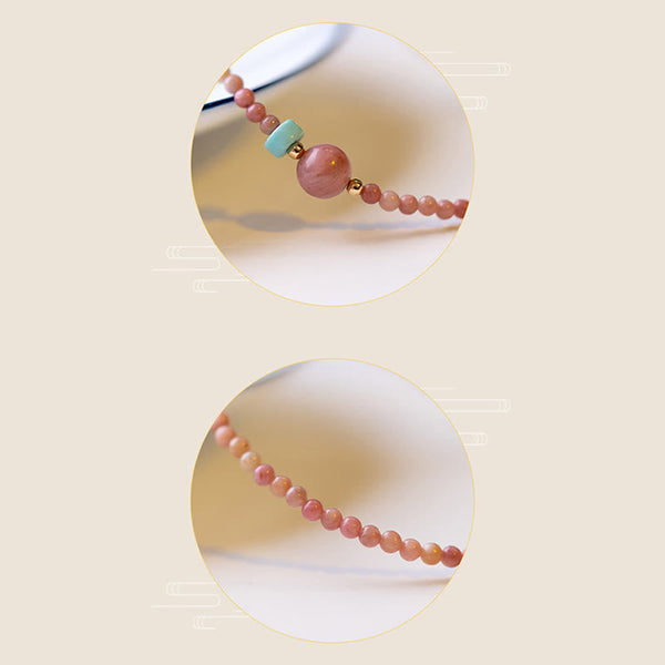 Rhodonite Loving Energy Bracelet – Polished pink stone beads with turquoise and gold accents in dual circular frames, cream background with Asian motifs