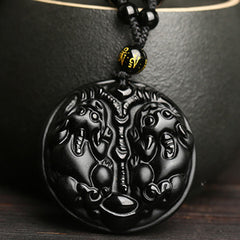 Double PiXiu Necklace – Black obsidian carved double PiXiu pendant against black ceramic cup, purification jewelry