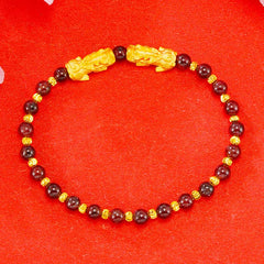 Golden Double PiXiu Bracelet – Dark red garnet beads with gold PiXiu pair and spacers on red, prosperity