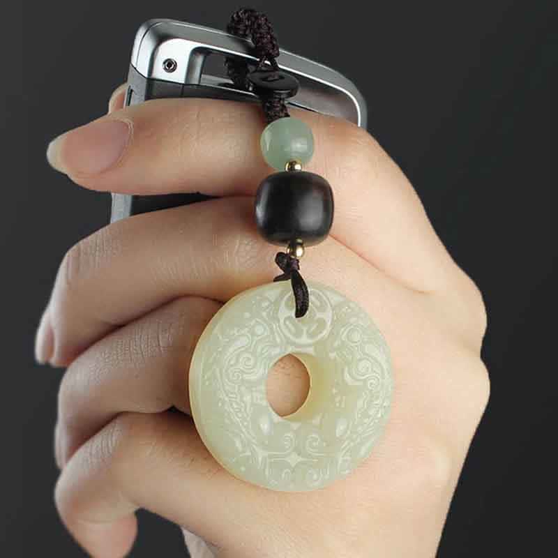 Jade PiXiu Peace Buckle Abundance Key Chain – Hand holding car key with jade peace buckle charm close-up, luxury