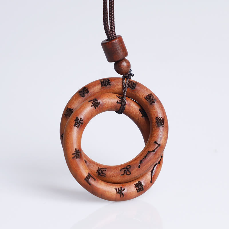 Qiankun Circle Necklace – White background hero shot of interlocking double-ring wooden pendant with burned Chinese seal scri