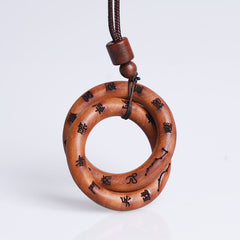 Qiankun Circle Necklace – White background hero shot of interlocking double-ring wooden pendant with burned Chinese seal scri
