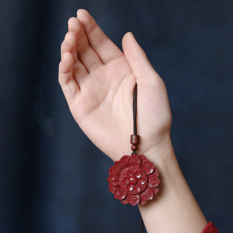 Cinnabar Om Mani Padme Hum Lotus Necklace – red lotus amulet held in open palm, peace necklace