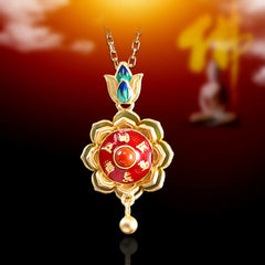 Lotus Prayer Wheel Pendant – gold mantra lotus with carnelian on black reflective surface, enlightenment