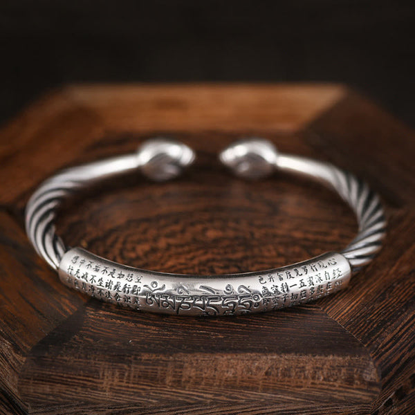 Tibetan Heart Sutra Cuff Bracelet – three-quarter view showing Chinese and Tibetan script, oxidized silver finish