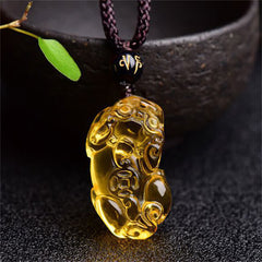Citrine PiXiu Necklace Pendant – Yellow citrine PiXiu on dark cord with mantra bead near bowl, prosperity