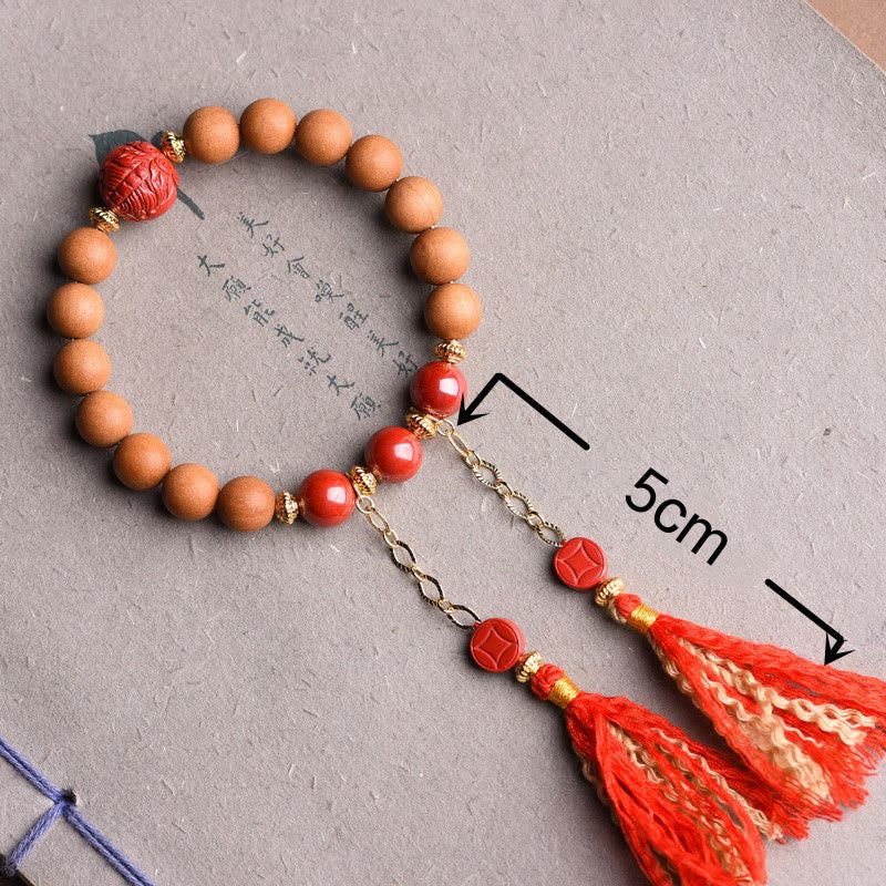 Peach Wood PiXiu Wealth Bracelet – Sandalwood and cinnabar bracelet with dual tassels on white, feng shui