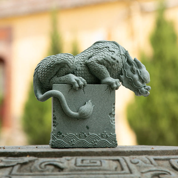 Feng Shui Dragon Sandstone Statue dragon on stone base, warm outdoor bokeh, three-quarter view, watchful
