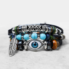 Tibetan Turquoise Evil Eye Bracelet – stacked leather and turquoise bracelet with silver nazar eye and feather detail