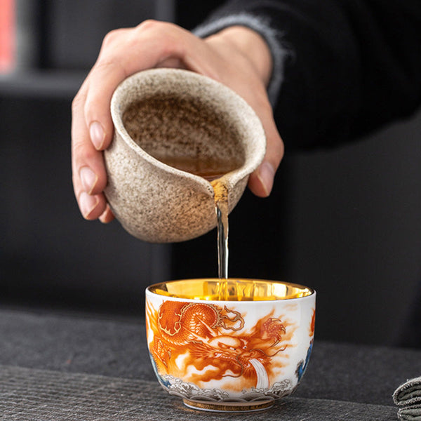 Dragon Phoenix Crane Gilt Ceramic Teacup – straight-on side view with orange dragon and wave motif, gold interior, white background