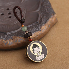 Ebony Avalokitesvara Keychain – close-up of compassionate face with closed eyes and crown, icon detail
