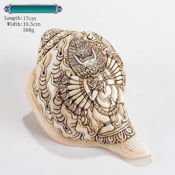 Engraved Shankha Wealth Conch – warm tungsten light on carved deity face, evening meditation ambiance