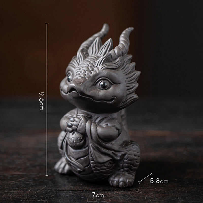Luck Dragon Tea Pet - terracotta and charcoal dragon duo on polished surface