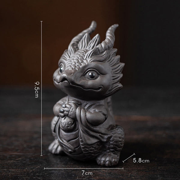 Luck Dragon Tea Pet - terracotta and charcoal dragon duo on polished surface