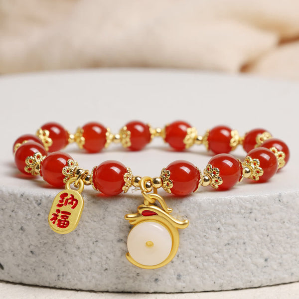 Red Agate Aventurine Dragon Bracelet – Red bead bracelet on stone pedestal with gold fortune charms, Prosperous