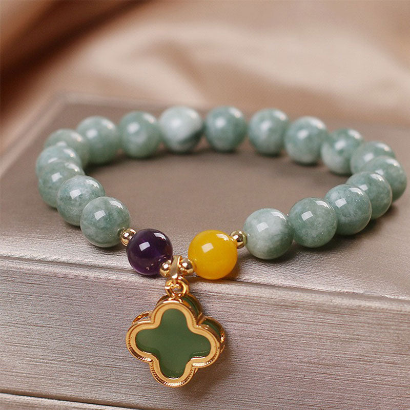 Green jade beaded stretch bracelet with amethyst and yellow jade accents, gold four-leaf clover charm, natural semi-precious stone jewelry