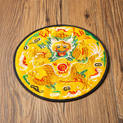 Dragon Embroidery Tea Cup Coaster Mat - yellow base with frontal coiled dragon top-down on wood, imperial symbolism