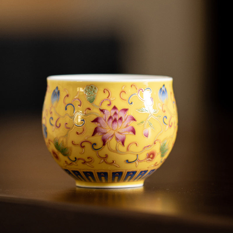 Lotus Pod Ceramic Tea Cup – yellow enamel lotus on dark wood tray, porcelain tea cup