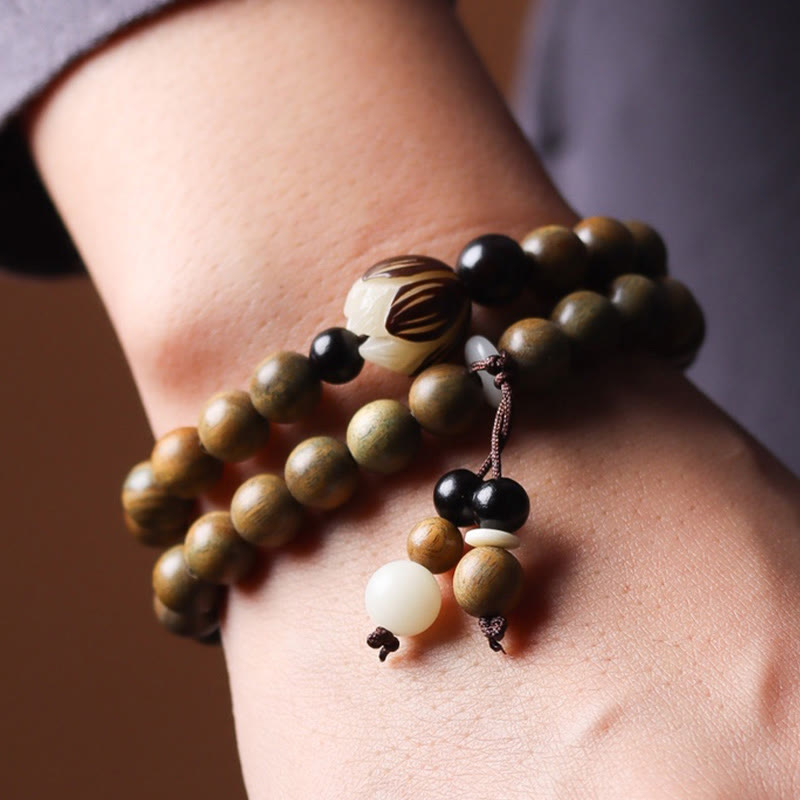 Green Sandalwood Lotus Bracelet – worn on wrist, carved lotus and wood grain close-up