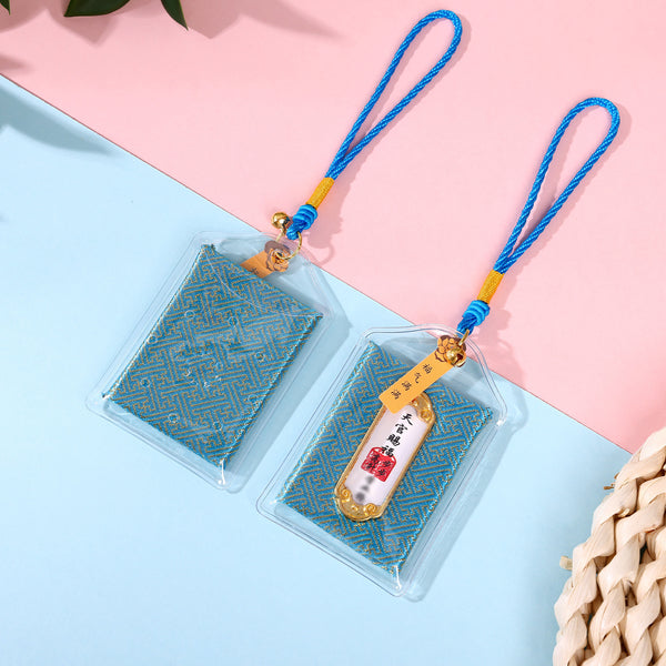 Two blue study blessing amulets on pink and blue background