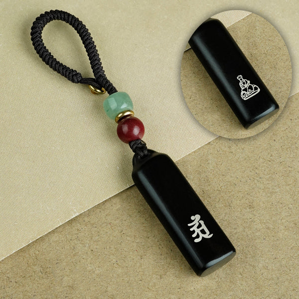 Eight ebony guardian talisman keychains collection display on black background with jade and cinnabar beads