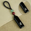 Eight ebony guardian talisman keychains collection display on black background with jade and cinnabar beads