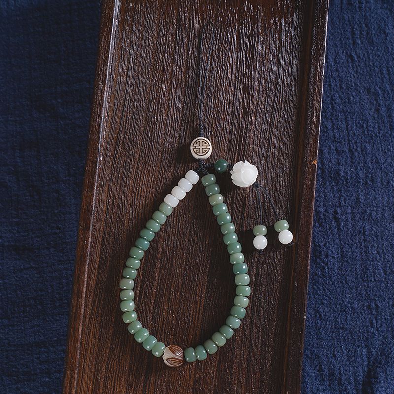 White Jade Bodhi & Jadeite Crystal Phone Charm – Green jadeite barrel beads with white lotus carving and gold fortune symbol pendant