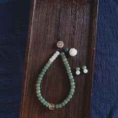 White Jade Bodhi & Jadeite Crystal Phone Charm – Green jadeite barrel beads with white lotus carving and gold fortune symbol pendant