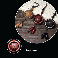 Feng Shui Sandalwood Keychain with Luminous Bead – Three wood variations displayed on calligraphy paper, Ebony detail close-up