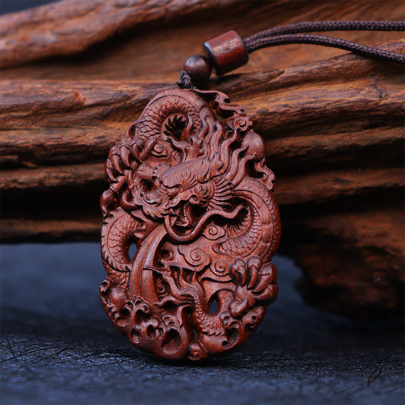 Lightning Jujube Wood Dragon Pendant - Close-up of dragon face with fangs on wood base, Handcrafted