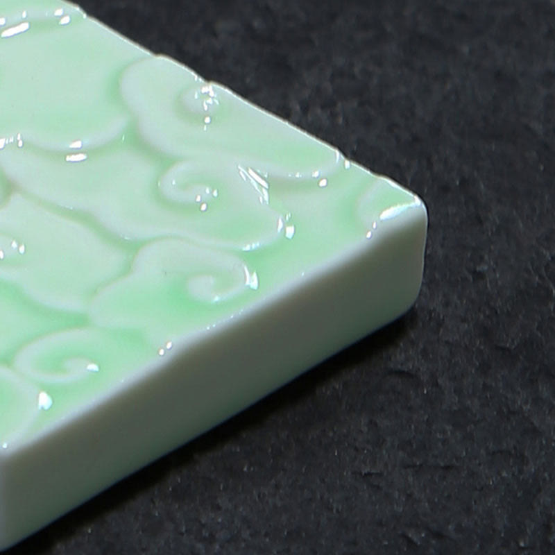 Mini Auspicious Clouds Ceramic Incense Burner – macro detail of celadon green embossed cloud pattern and glossy glaze edge, ceramic burner