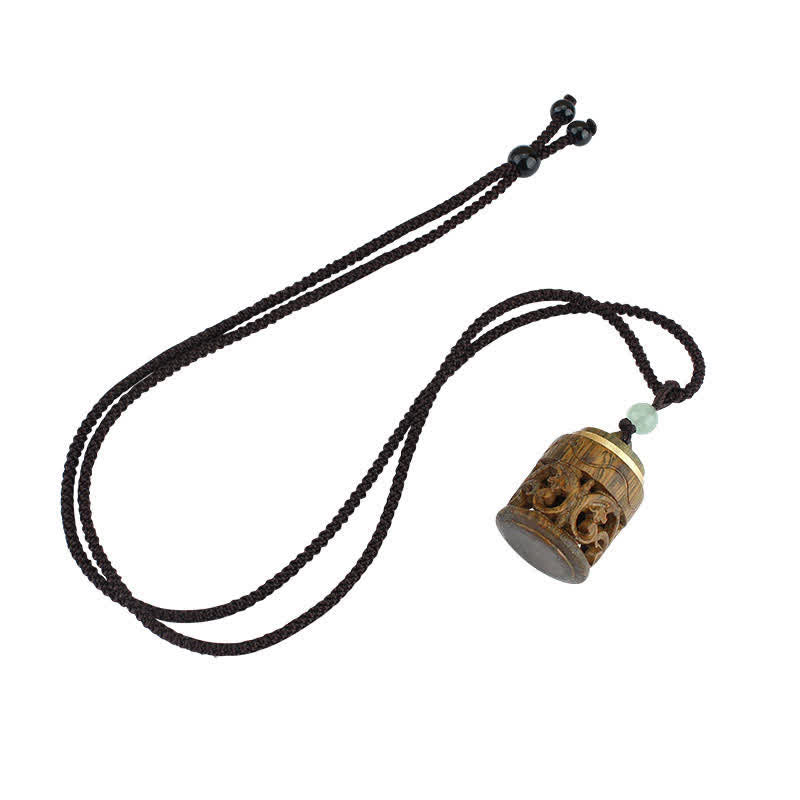 Om Mani Padme Hum Necklace – Adjustable brown cord with carved wooden prayer wheel, gold bands, green bead, white bg