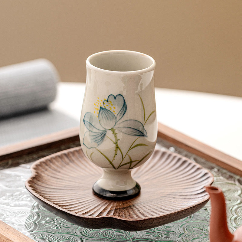 Hand Painted Lotus Tea Cup – tea pouring into stemmed lotus cup on linen coaster, terracotta pot, dynamic ritual