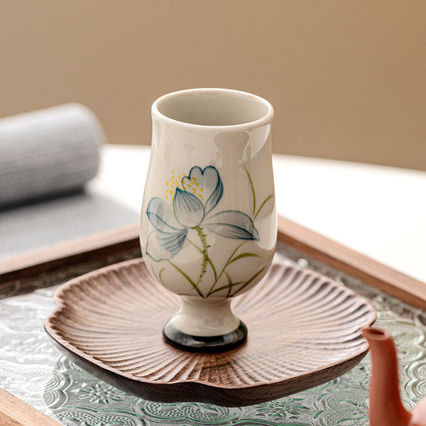 Hand Painted Lotus Tea Cup – tea pouring into stemmed lotus cup on linen coaster, terracotta pot, dynamic ritual