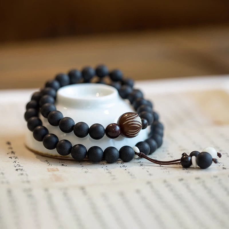 Tibetan Cypress Bodhi Lotus Bracelet - dark mala on antique scroll with carved guru bead, calming