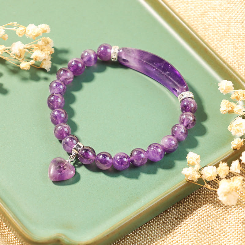 Natural Multi-Stone Love Heart Healing Bracelet - Amethyst bracelet styled on sage green ceramic surface with dried baby's breath flowers