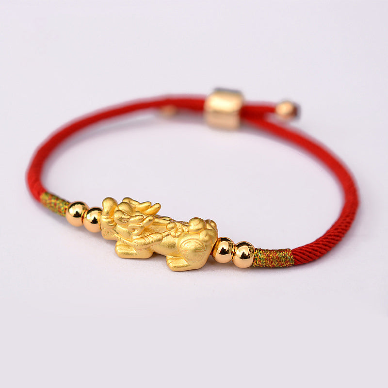 Gold-Plated PiXiu Red String Bracelet – gold PiXiu and red string bracelet side view, white background studio