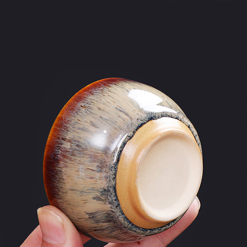 12 Zodiac Jian Zhan Teacup - hand-held cup revealing unglazed foot ring, metallic hare fur glaze in rust and silver